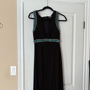 Long black double lined stretchy elegant  dress with a slit.
